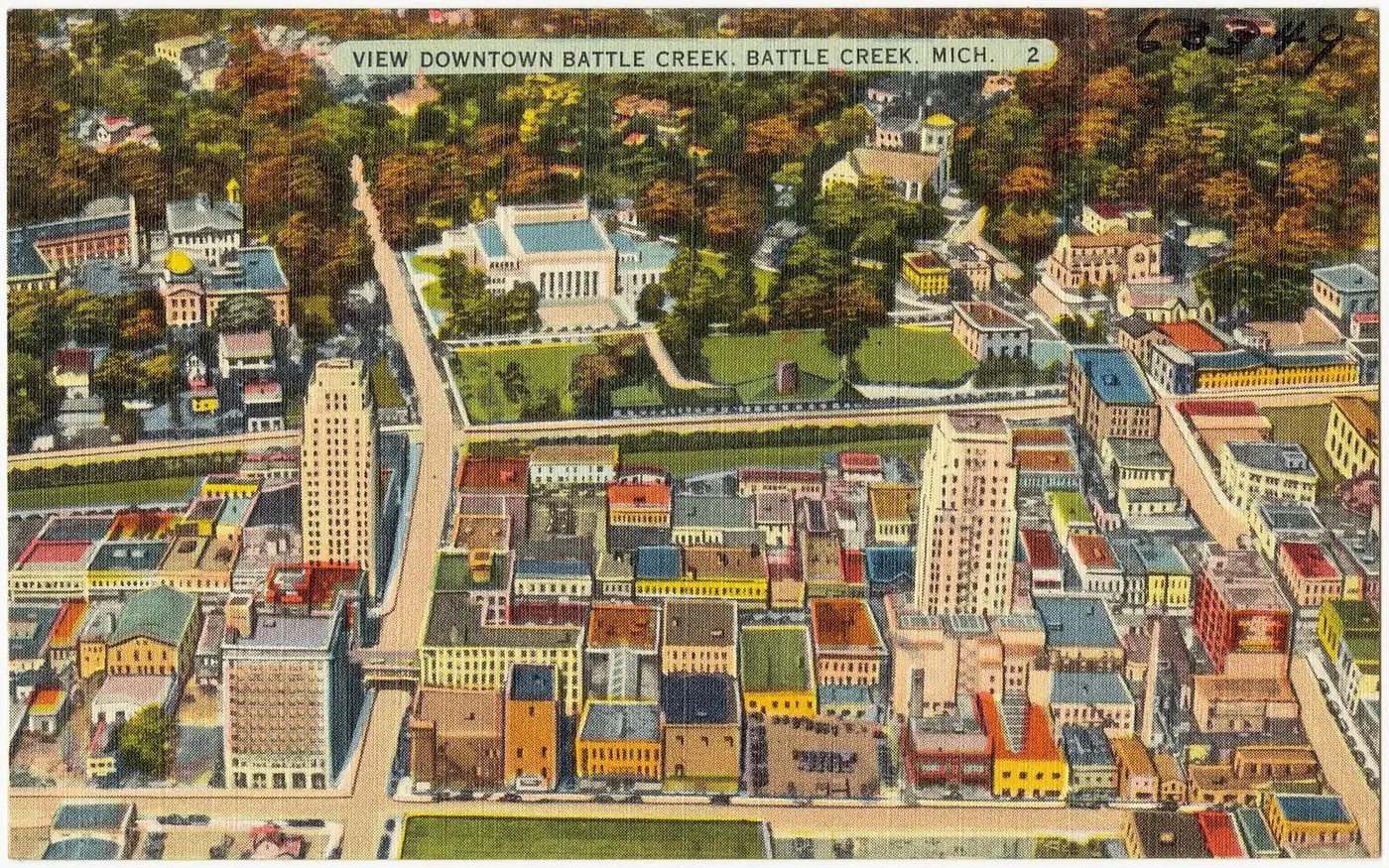 Vintage linen postcard showing a bird's-eye view of downtown Battle Creek with tall buildings and tree-lined streets